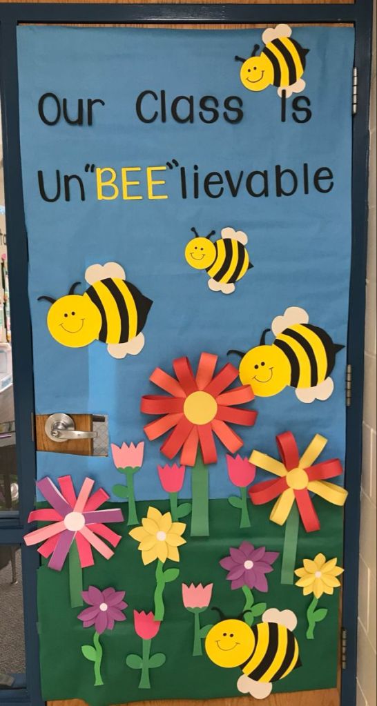 Bee-themed classroom door with cheerful buzzing bees and the phrase 'Our Class is UnBEE-lievable'.
