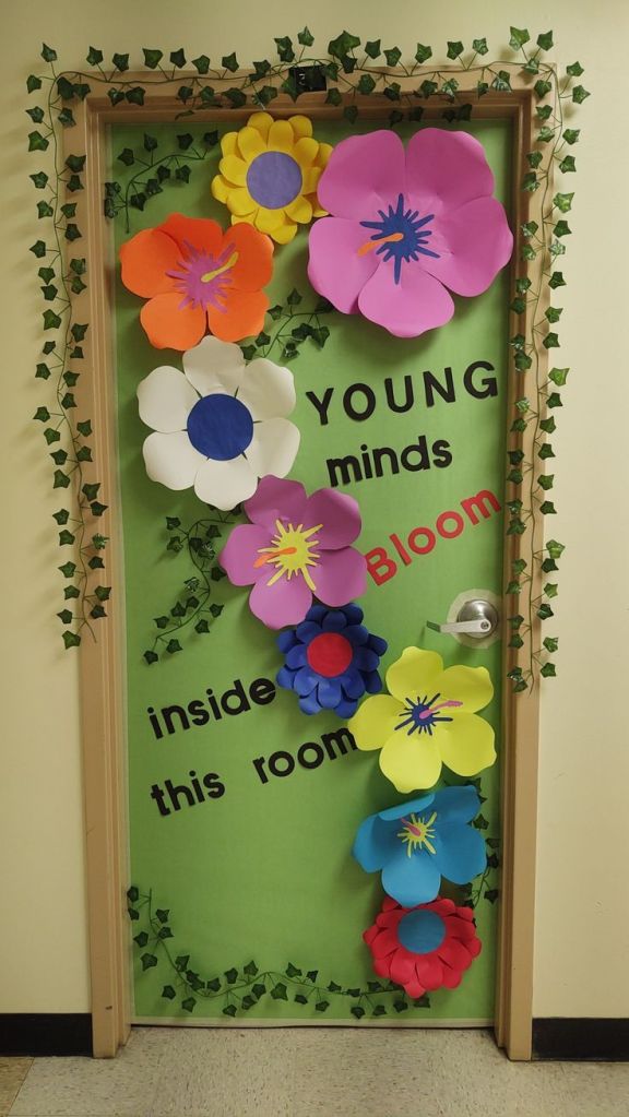 Spring classroom door with 3D paper flowers and ivy vines – a perfect decoration for welcoming students.