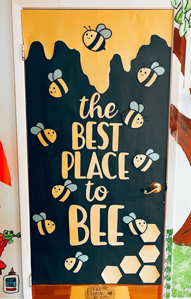 Honeycomb-themed classroom door with smiling bees and golden honey drips, creating a warm and inviting atmosphere.