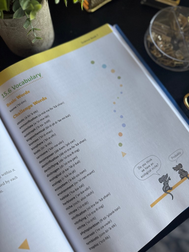 A close-up of a vocabulary page from Real Science 4 Kids Book 7, showing listings of basic and challenge words with definitions.