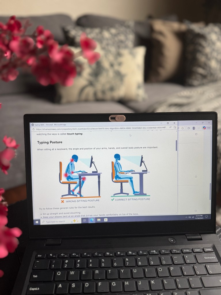 A laptop displaying a lesson on typing posture, featuring illustrations of correct and incorrect sitting positions while typing, with text outlining key points about maintaining proper posture.