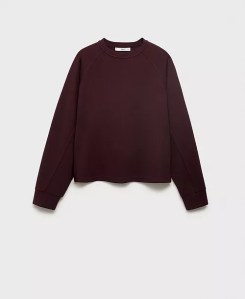 A maroon crewneck sweatshirt with long sleeves, displayed on a plain background.