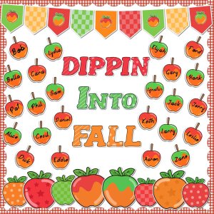 A decorative fall-themed bulletin board display featuring the phrase 'DIPPIN INTO FALL' in colorful letters, surrounded by apple cutouts and names hanging from strings.