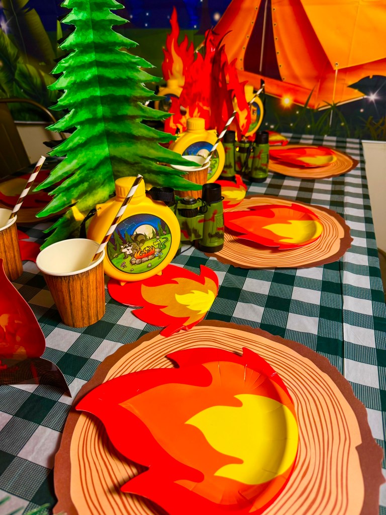 Great Wolf Lodge inspired campfire centerpiece with lanterns and woodland birthday party decor.