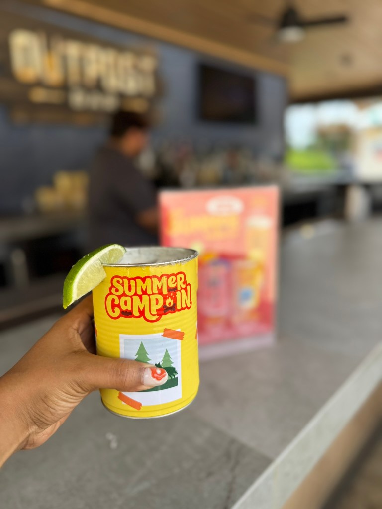 Specialty margarita for Summer Camp In being held over bar at Outpost Bar at Great Wolf Lodge in Grapevine, Texas