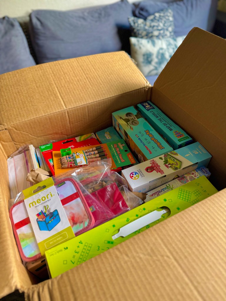 Open Timberdoodle Kindergarten Curriculum Kit filled with homeschool books, games, art supplies and learning activities.