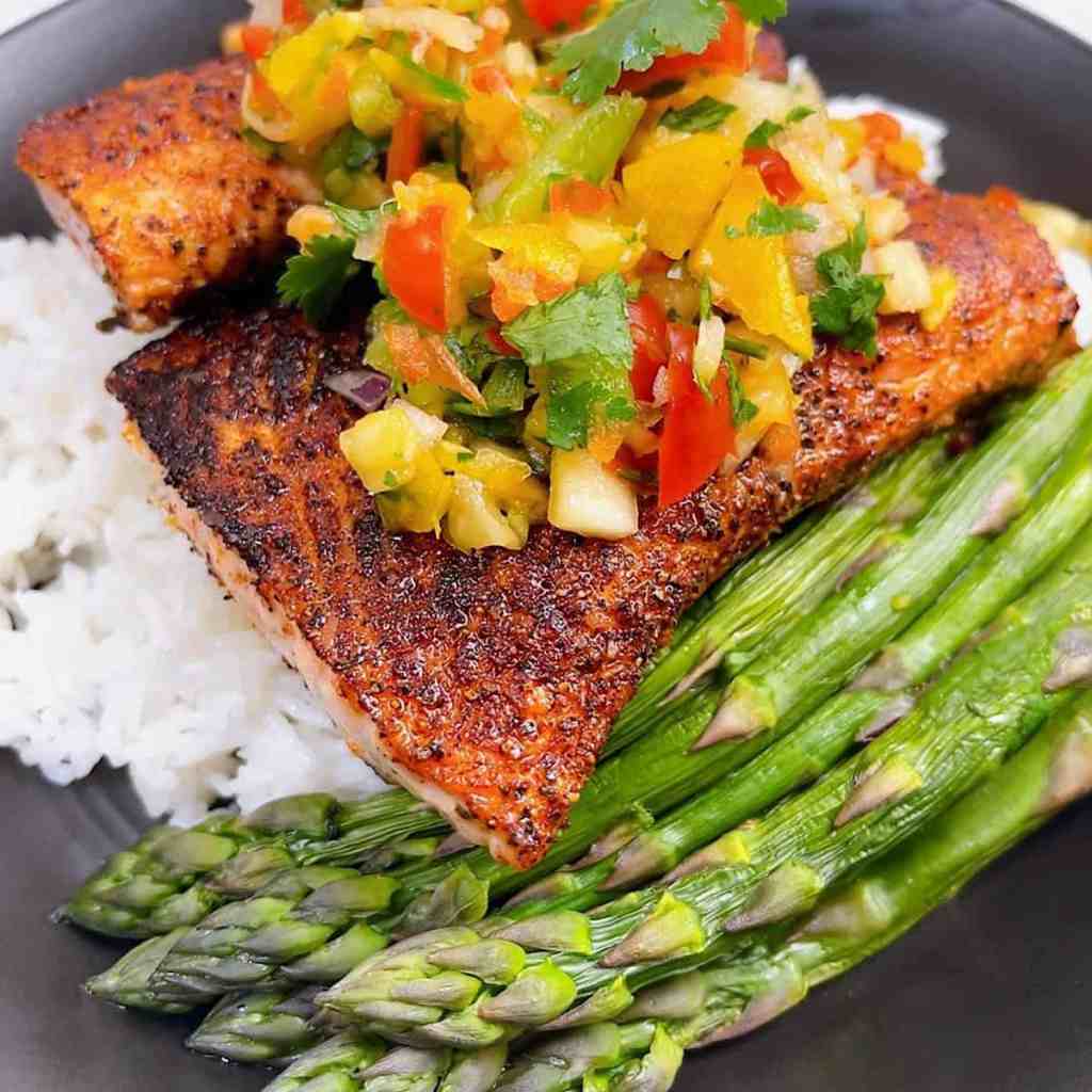 Blackened salmon topped with pineapple habanero salsa for a bold summer seafood dinner.