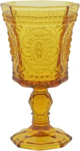 A vintage-inspired amber glass goblet with intricate detailing, perfect for enhancing a Thanksgiving tablescape.