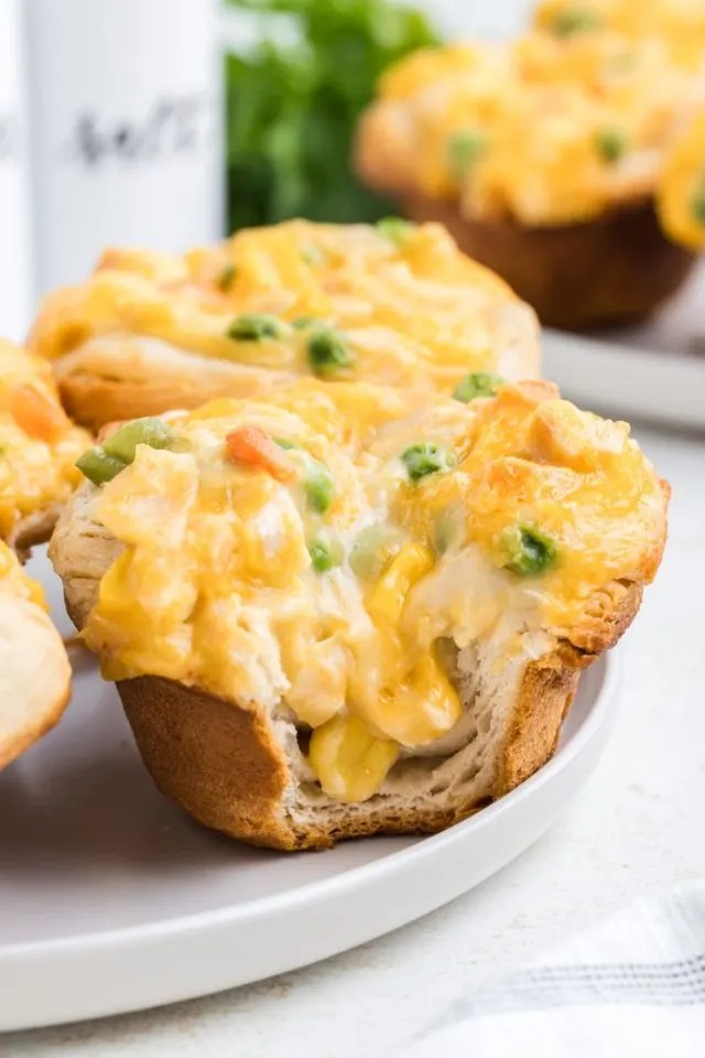 Mini chicken pot pies with biscuit crust and creamy chicken vegetable filling baked golden