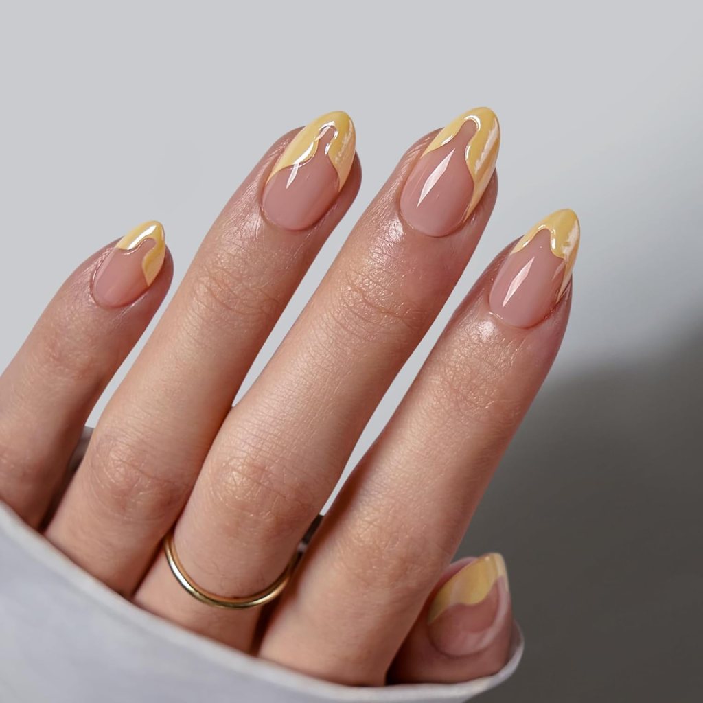 Butter yellow swirl French tip nails with abstract pastel wave nail art on short almond shaped nails