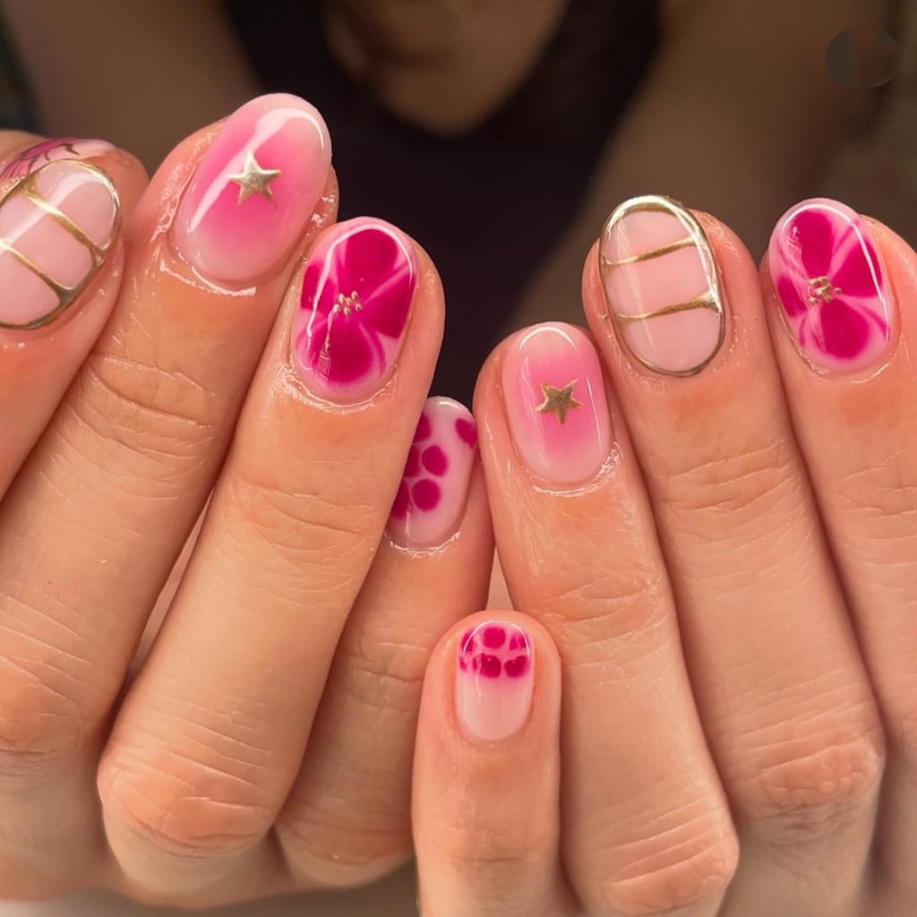 pink hibiscus short nails with gold details and tropical vibe
