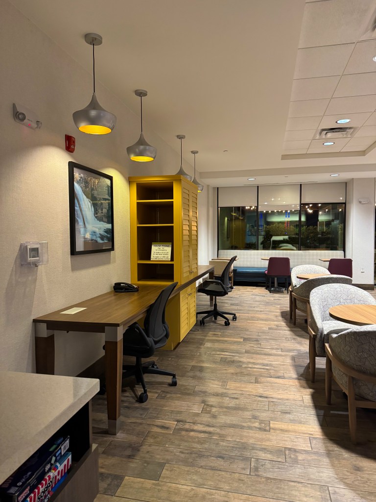 Lobby workspace with desks, chairs and additional seating at Home2 Suites Pigeon Forge.