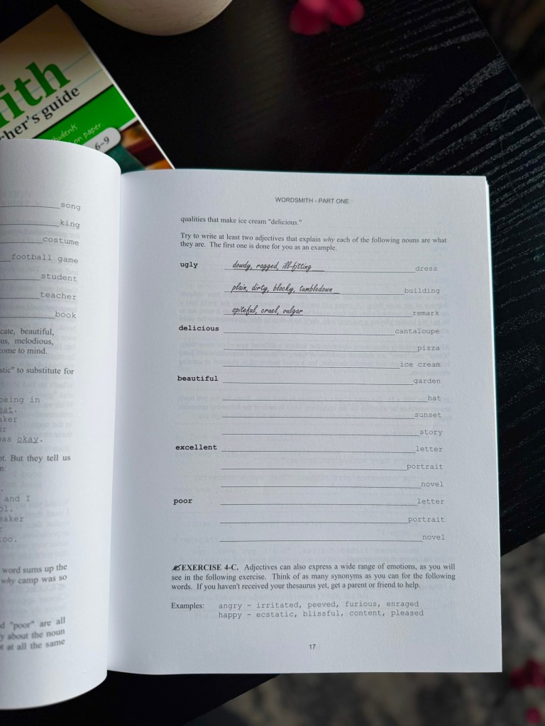 Page from a workbook titled 'WORDSMITH - PART ONE' featuring an exercise on adjectives to describe nouns. The page includes prompts for various qualities and examples like 'ugly' and 'delicious'.