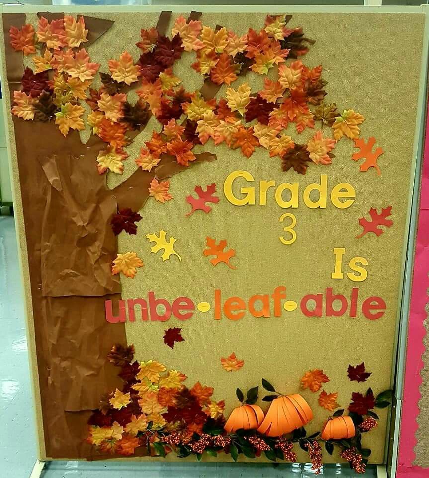 Third grade fall bulletin board with a large autumn tree, pumpkins, colorful leaves and Grade 3 Is Unbe-Leaf-Able lettering.