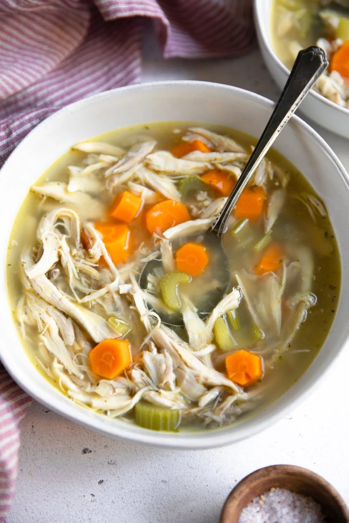 Cozy fall chicken soup with carrots, celery, and shredded chicken
