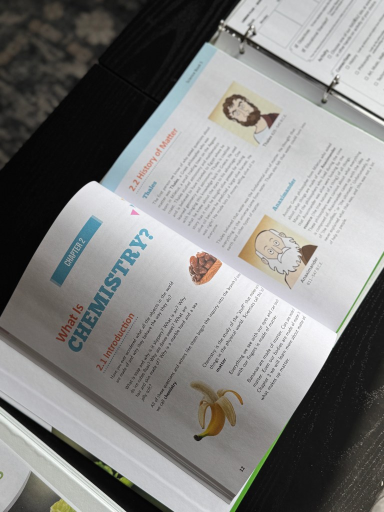Open page from Real Science-4-Kids Book 5 featuring a section on chemistry, including the title 'What is Chemistry?' and illustrations of a banana, chocolate, and notable historical figures in chemistry.