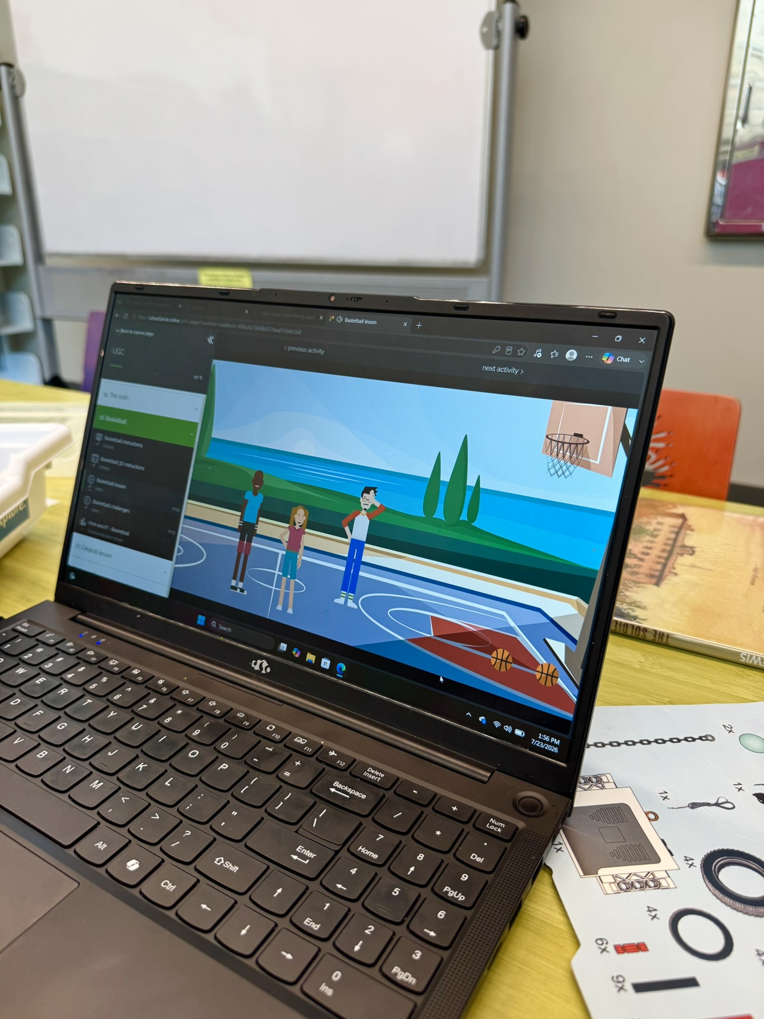 Laptop screen showing an animated basketball lesson with three characters on an outdoor court near water