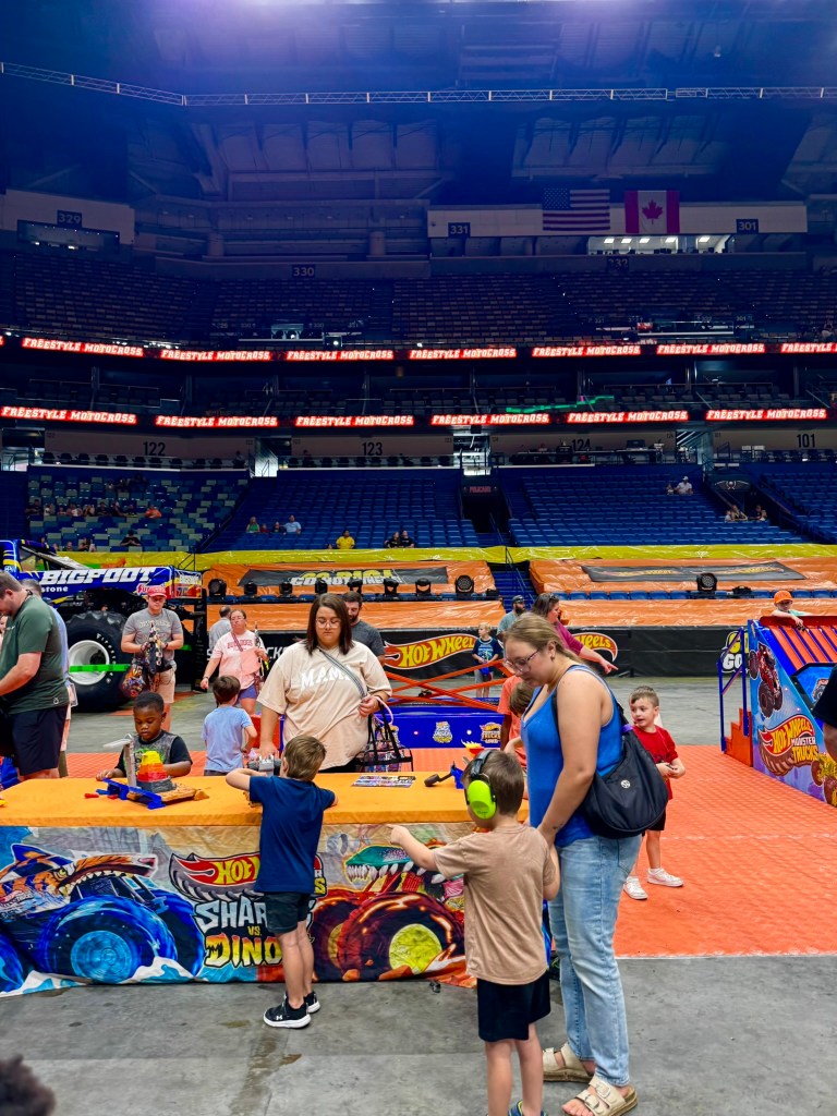 Families and children gathered around an activity table during the Hot Wheels preshow.