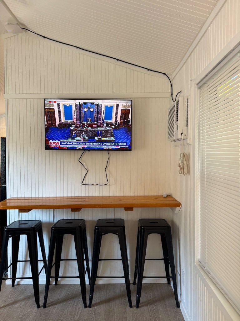 Television mounted above the doorway inside a Jellystone Park Pigeon Forge cabin bedroom