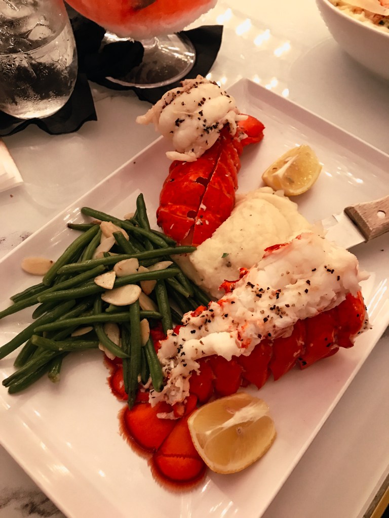 Lobster tail entrée served with seasonal sides at Sugar Factory Biloxi during the Christmas holiday season.