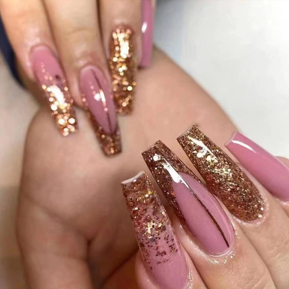 Close-up of hands featuring long, pink nails with glittery rose gold accents.