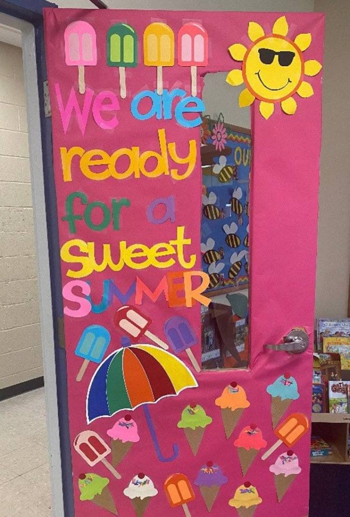 Colorful classroom door decor featuring the phrase 'We are ready for a sweet summer' with images of popsicles, ice creams, and a sun with sunglasses.