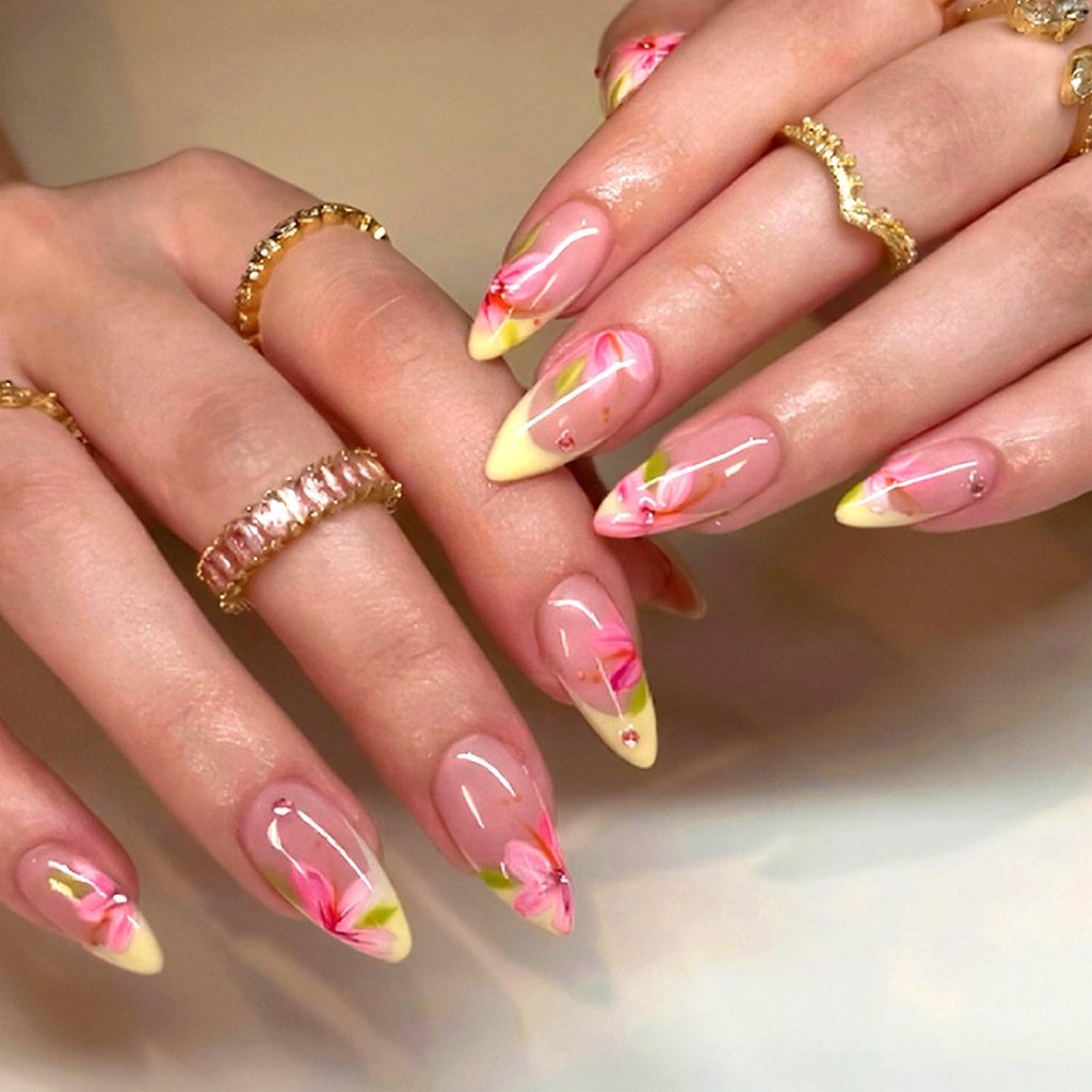 Glossy butter yellow almond nails with tiny yellow daisy flower nail art and pastel French tips