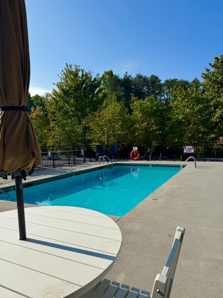 Family swimming pool and seating area at Jellystone Park Pigeon Forge