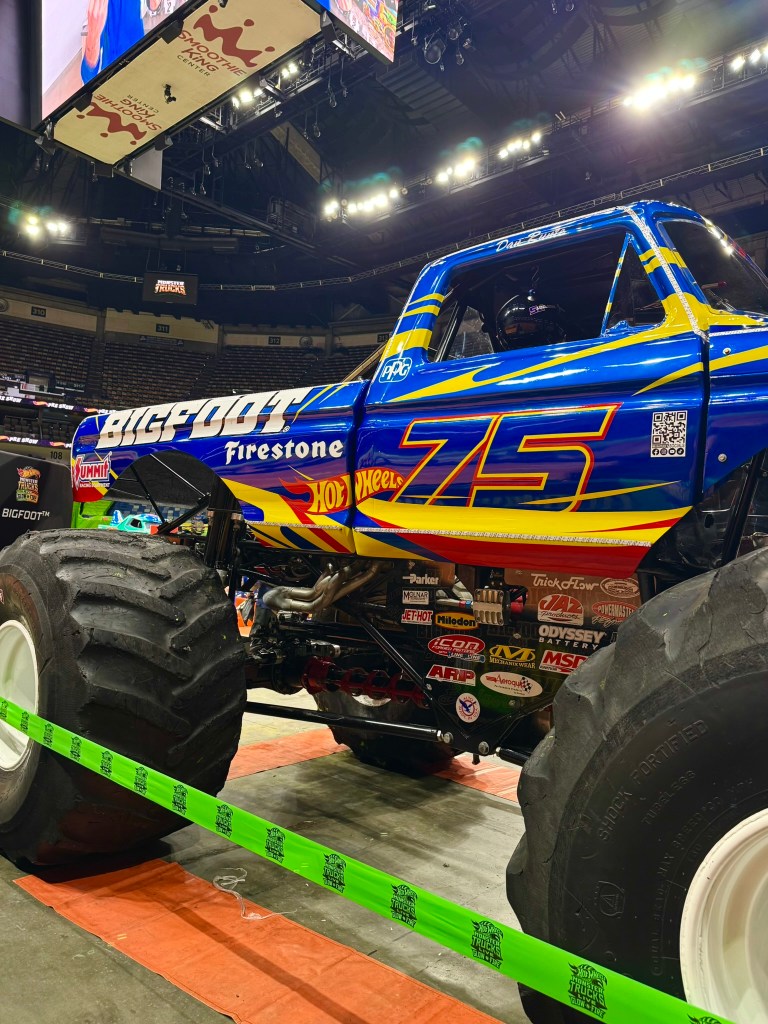 Blue, yellow and red Bigfoot monster truck displayed during the New Orleans preshow.