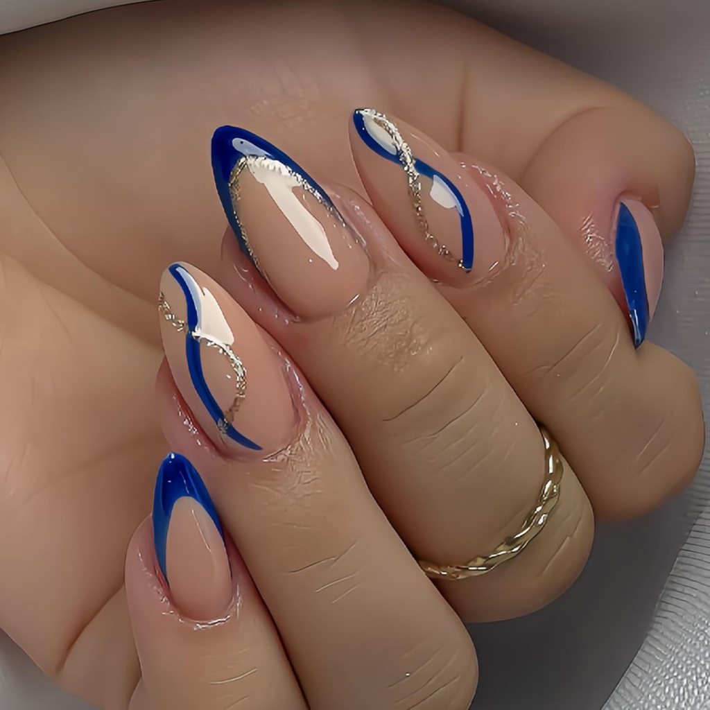 Blue and gold swirl French tip almond nails with metallic gold accents and glossy nude polish.