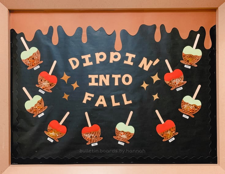 Dippin' Into Fall classroom bulletin board displaying student caramel apple crafts against a simple black background.