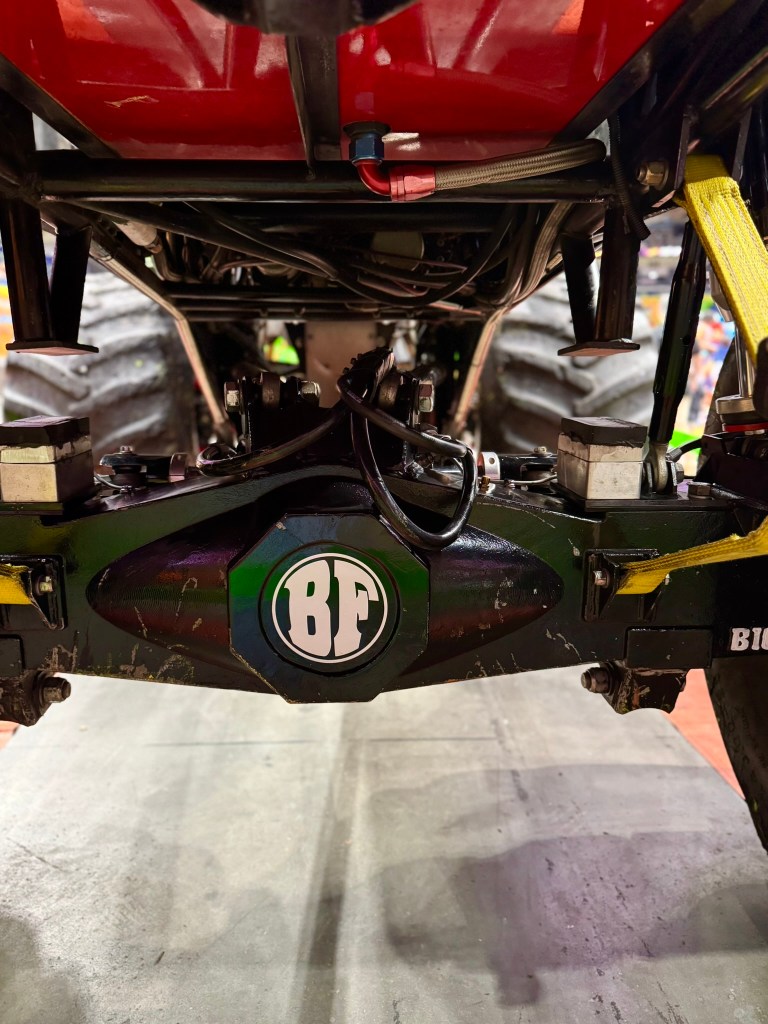 Detailed close-up of the Bigfoot monster truck rear axle and undercarriage.