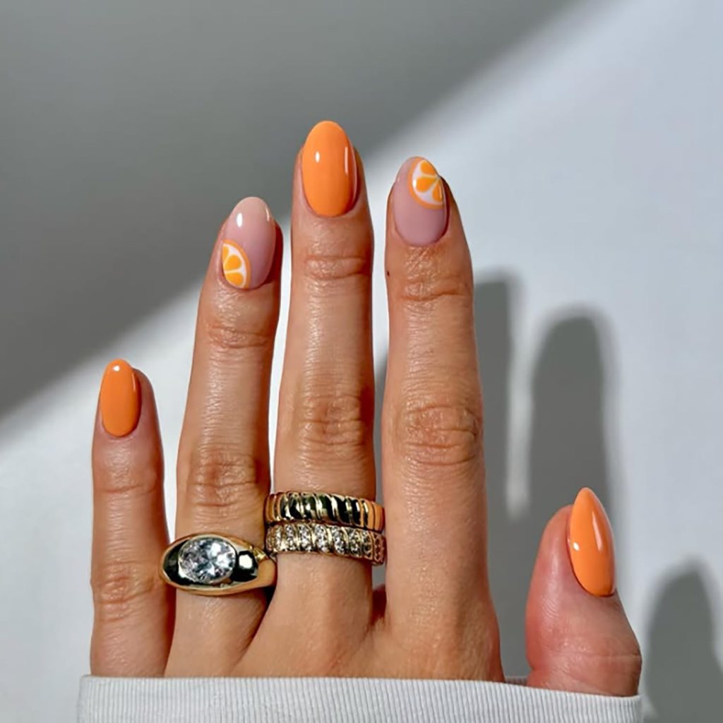Short square nails painted in glossy orange polish with a clean minimal look