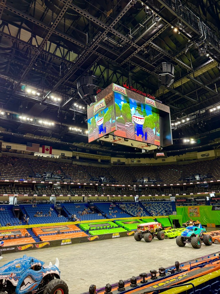 Rhinomite and Bigfoot positioned on the arena floor before Hot Wheels Monster Trucks Live.