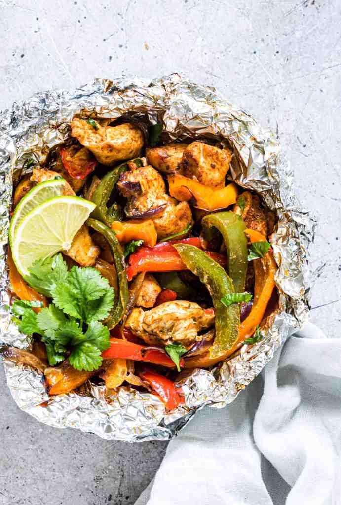Chicken fajita foil packets with seasoned chicken, peppers, and onions for an easy summer dinner.