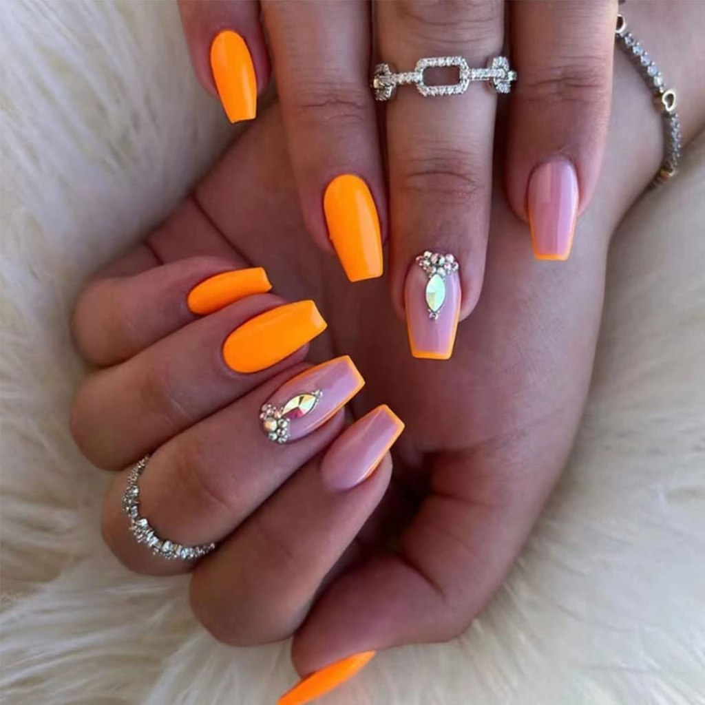 Neon orange nails with glossy finish and rhinestone accent nail