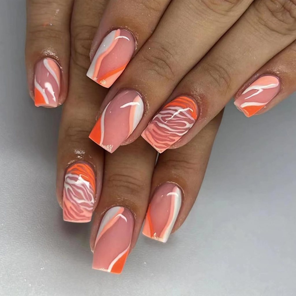 Short square nails with orange and white swirl abstract nail art