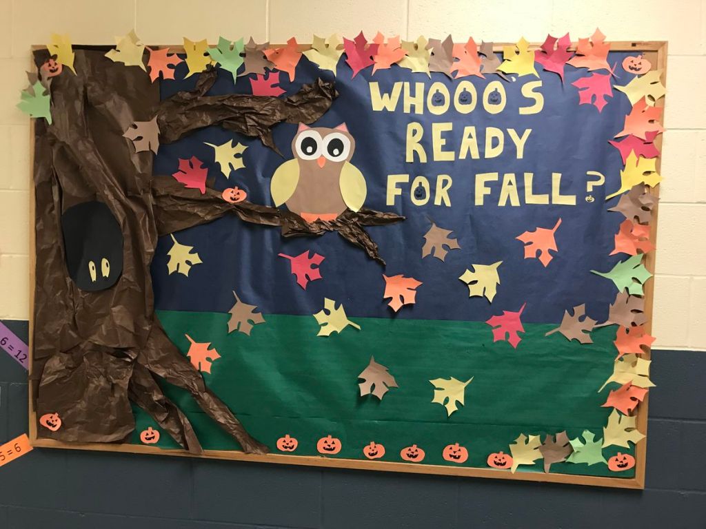 Owl fall bulletin board with a large brown paper tree, colorful leaves, pumpkins and Whooo's Ready for Fall lettering.