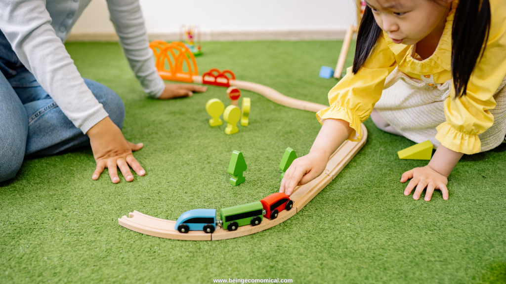 Preschooler playing with a wooden train set during hands-on homeschool preschool learning.