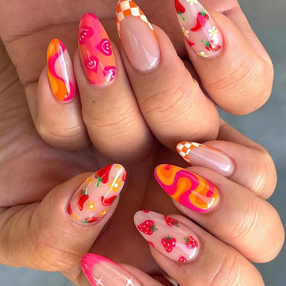 Colorful and creative nail art featuring various designs including strawberries, cherries, floral patterns, and vibrant abstract shapes on long almond-shaped nails.