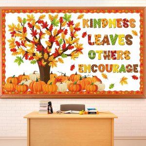A colorful wall display featuring a tree with autumn leaves and pumpkins, accompanied by the words 'Kindness Leaves Others Encourage'.