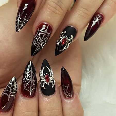 Gothic nails featuring black and deep red designs with spiderwebs and metallic spider accents.