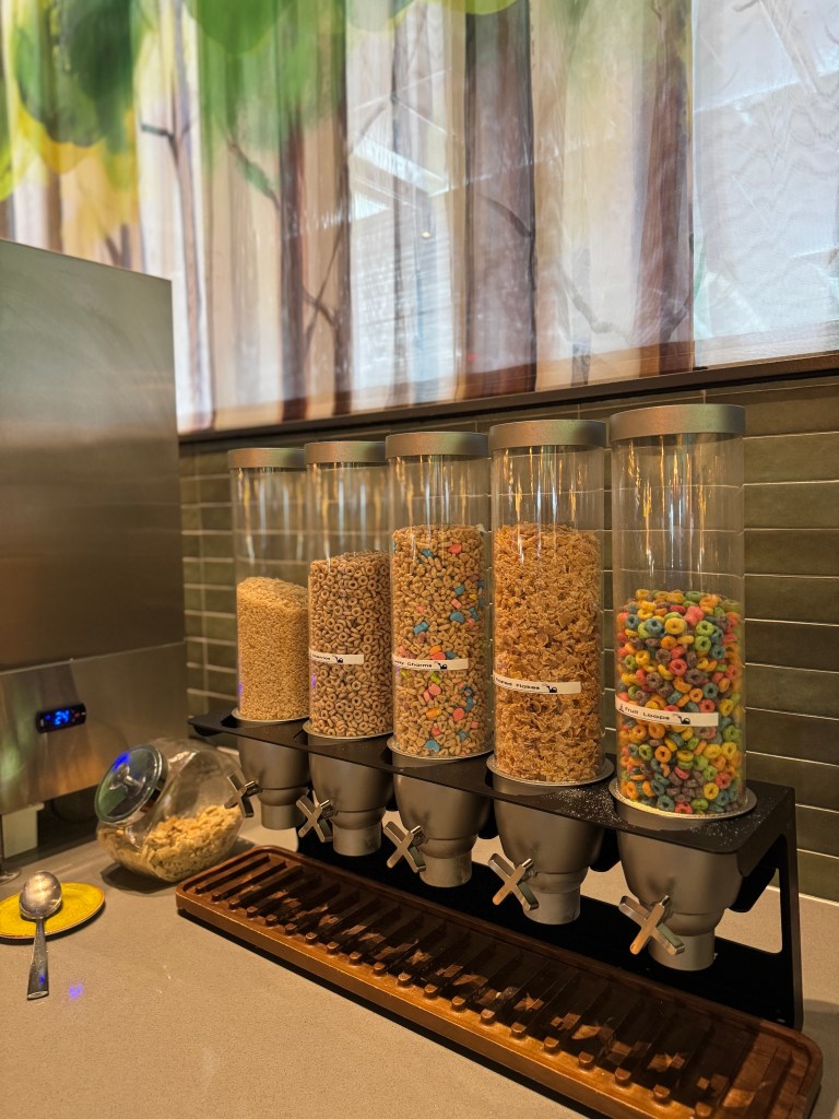 A selection of cereal dispensers featuring various types of cereals, with a cozy, nature-themed backdrop.