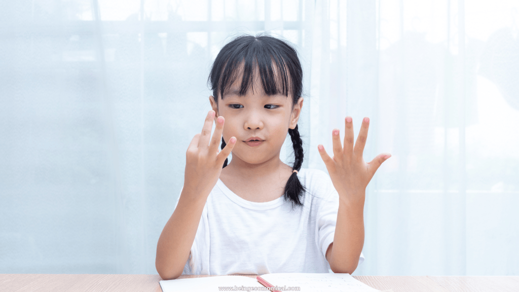 Young child counting on her fingers during an easy preschool math activity