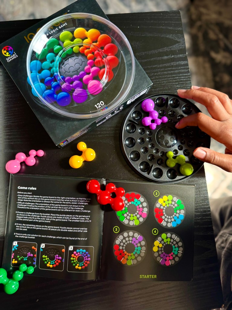 Child placing a purple IQ Circle puzzle piece onto the circular game board