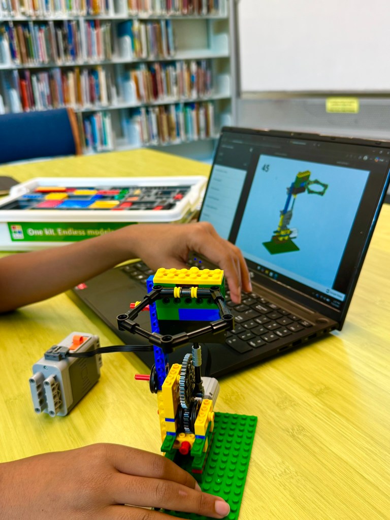 Student following online iBrick engineering directions for a vehicle model