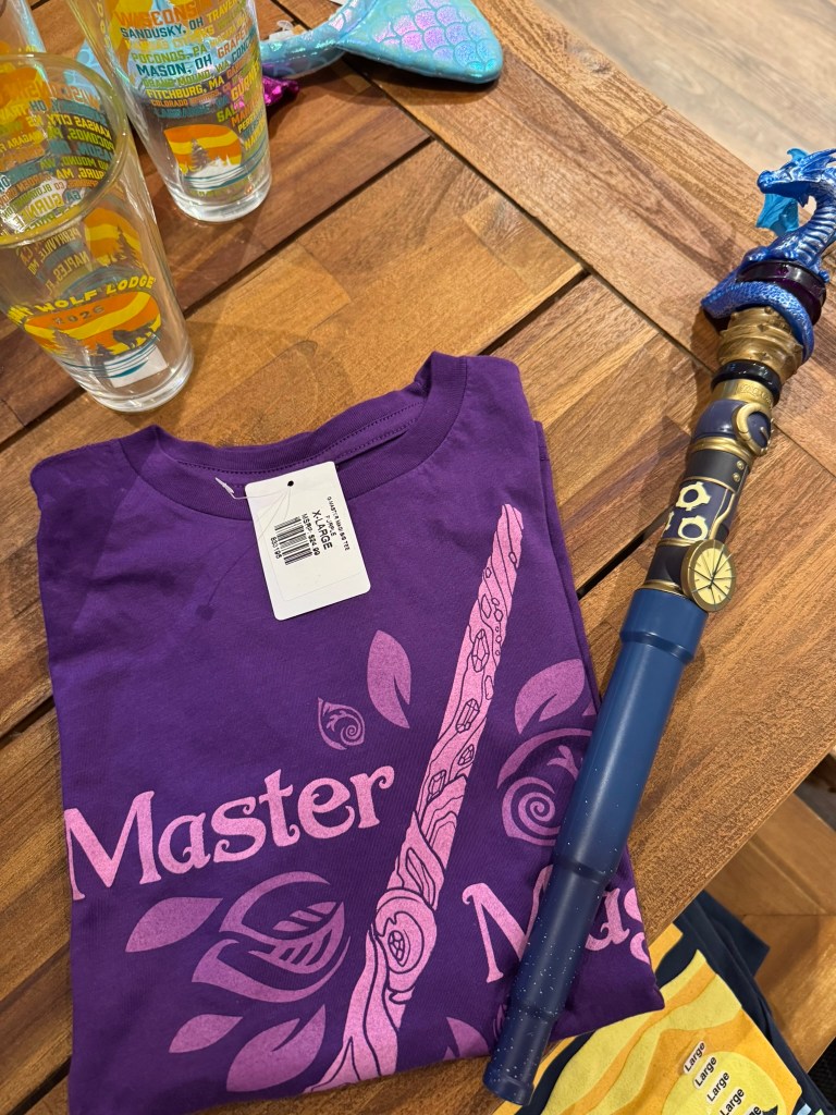 Master Magi T-shirt and MagiQuest dragon wand displayed in the Great Wolf Lodge Grapevine gift shop.