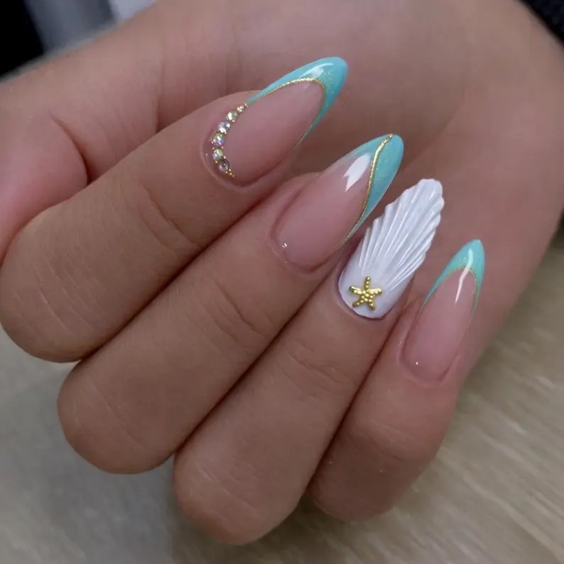 Turquoise ocean French tip nails with 3D seashell art, gold details, and beach-inspired summer manicure design