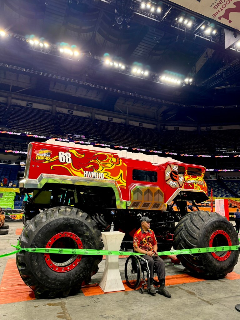 Red HW 5-Alarm fire truck monster truck with flame graphics and oversized tires.