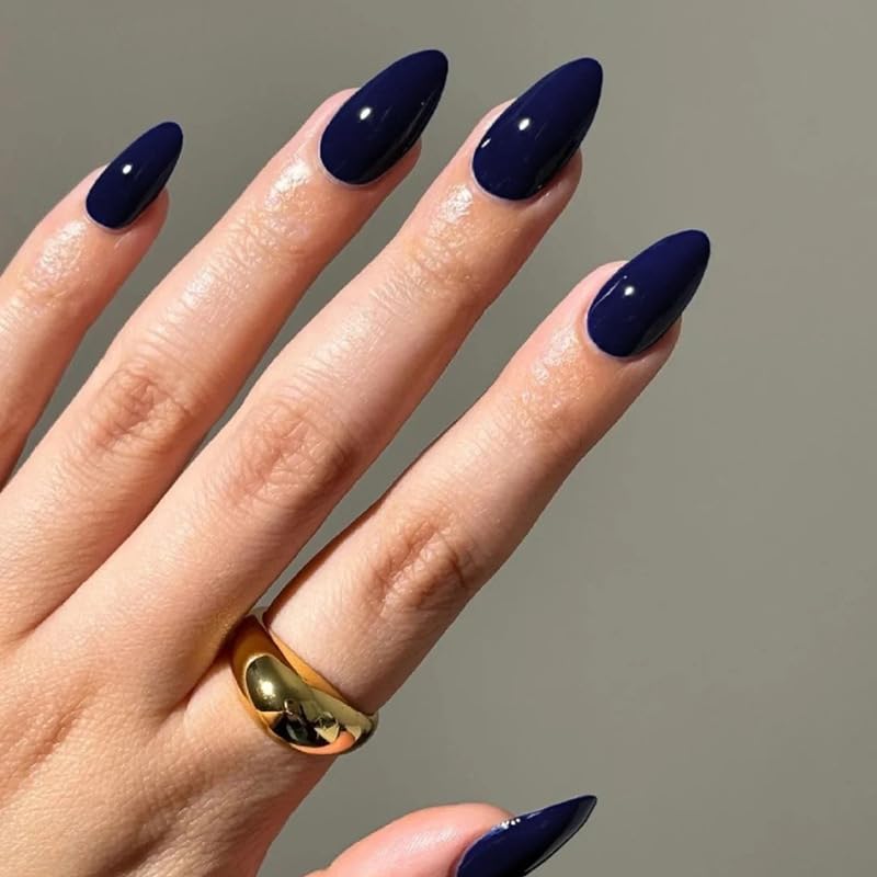 Solid glossy navy blue almond nails with a sleek dark blue manicure and minimalist nail design.